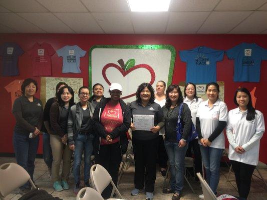 The whole group with Ms. Lynette at Minnie's Food Pantry after volunteering.