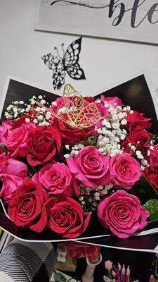 25 premium hot pink and red roses in a hand tied bouquet