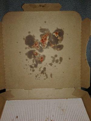 Pizza hut box with pizza on top separately from pizza because a 2 liter of soda was on top of it.