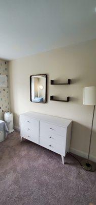 I assembled this dresser and mounted these shelves and mirror for a client's nursery.