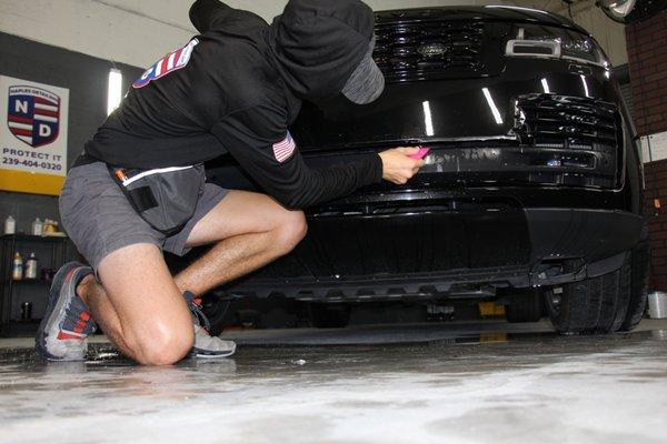 Applying Paint Protection Film to the front bumper of a 2022 Range Rover HSE, giving this car superior protection from chips and scratches.