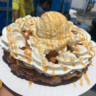 CHURRO FUNNEL CAKE topped with VANILLA ICE CREAM and CARAMEL DRIZZLE