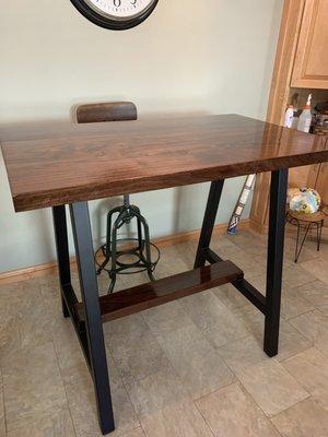 Slab walnut table mounted on powder coated custom welded legs.