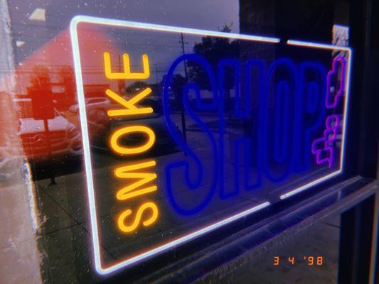 Smoke shop sign at Golden Mango