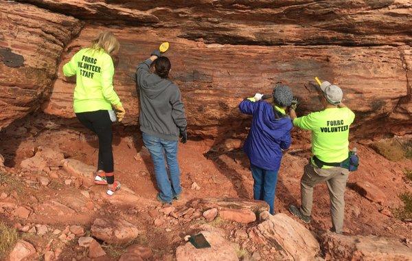 Volunteers working very hard to clean graffiti from a rock. Thank you "Friends of Red Rock Canyon."