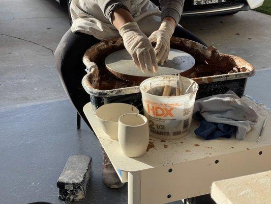 Demonstrating the clay throwing process