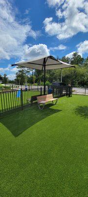 Sun shade with bench. Installed in a dog park.