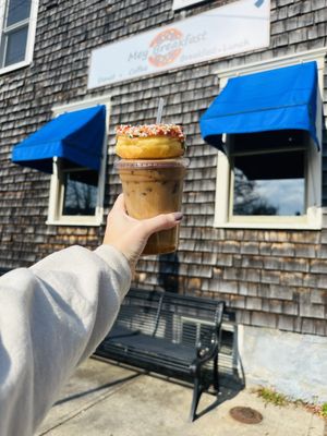 Their store front featuring a medium iced caramel latte and a sprinkled maple donut.