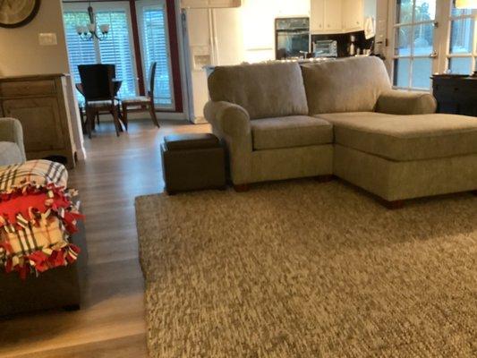 New floor and replaced furniture in family room looking into kitchen eating area