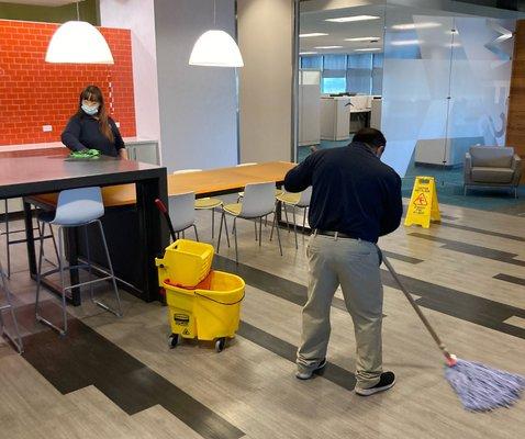 REDLEE/SCS staff cleaning break room at an office.