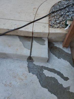 Water coming out from uncapped sprinklers under2 ft of cement