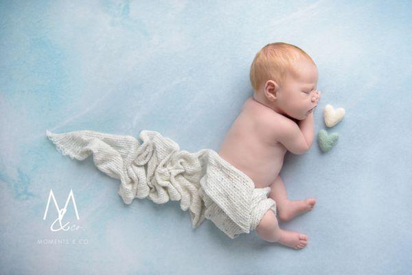 Newborn Boy sleeping on a cloud with hearts by his side