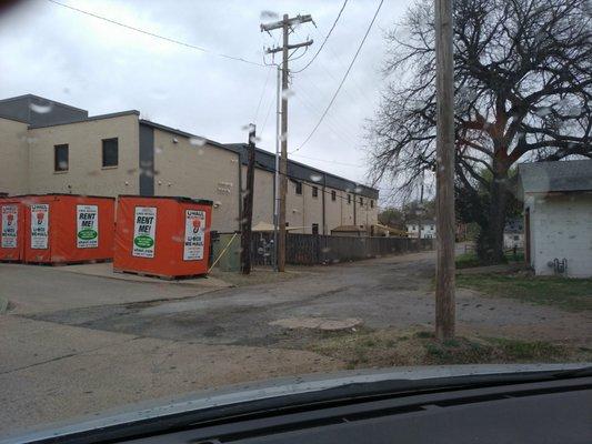 Alley behind building. Delivery and parking.