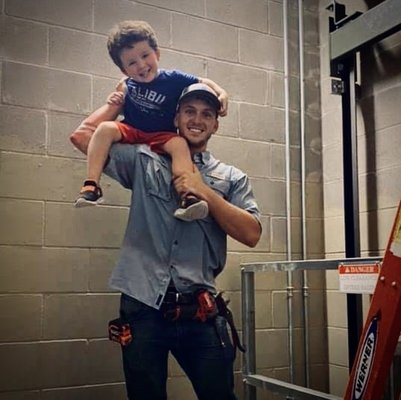 Myself and my son working in an elevator shaft! Commercial electrician in training.