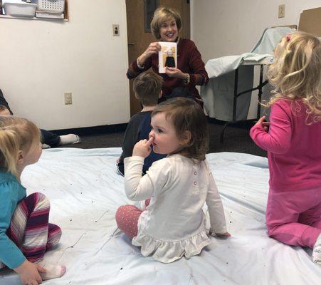 The little girl on the right is SO excited to see herself in our class story book.