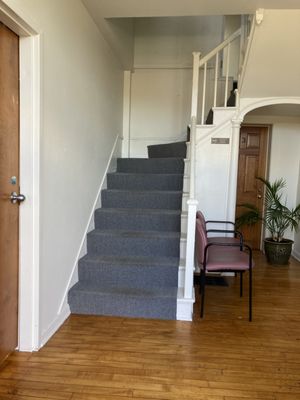 Inside front entrance. Take stairs to the 2nd floor for the office.