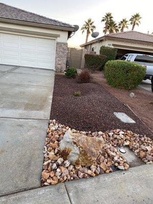 Layered 3-4" Cinnabar crushed rock on the edge of the property. Installed (5) 1'x1.5' Boulders. (2) 1.5'x3' Boulders. 1/2" Southwest brown