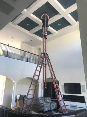 One of our electricians installing a high mounted light fixture.