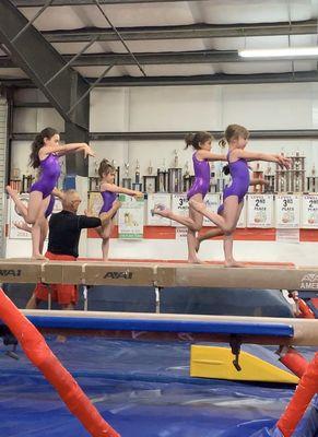 Jim coaching the level 2 on beam.