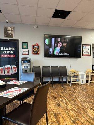 A large TV is running with audio so you can watch a movie while you eat.