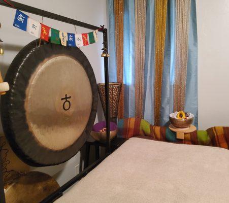 A wooden bed for Vibrational Sound Therapy with this Earth Gong and Tibetan Singing Bowls.