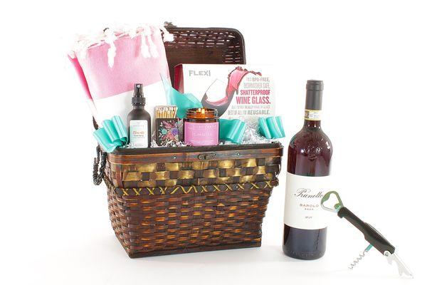 A luxury gift basket with self-care items for the home plus a bottle of wine