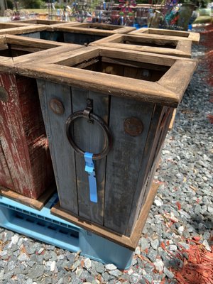 Neat wooden containers for plants or umbrellas.