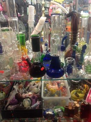 A bunch of bongs with a wider selection inside including all sizes, shapes, and colors. Very affordable comparing to the village