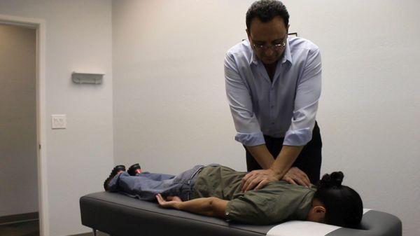 Gilroy CA Back Pain Specialists - Dr. Sam performs back adjustment therapy. First Chiropractic 408-848-6222