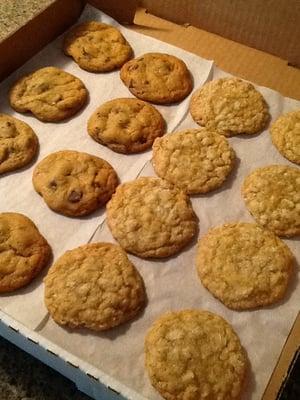 Split box of warm cookies, half chocolate chip, half oatmeal