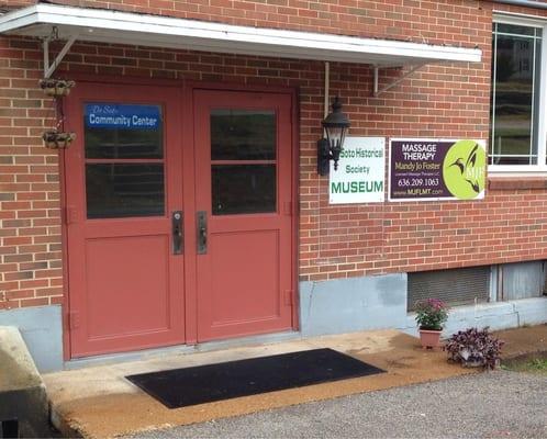 Main entrance from gravel parking lot in rear of the center