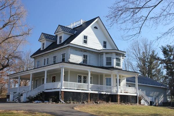 19th Century House with Black Standing Seam Metal Roof with Widows Porch