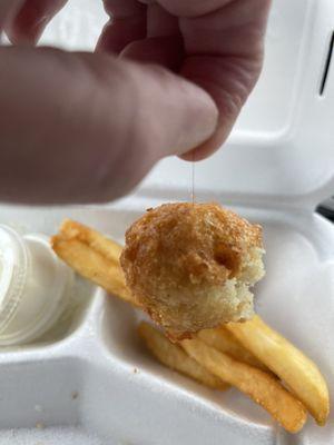 Hush puppy hanging by the hair, proving it was cooked into it not laying on top