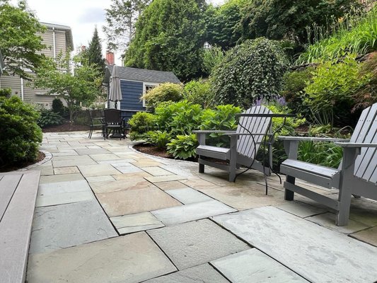 Bluestone patio, with natural stone retaining wall. back yard scape.