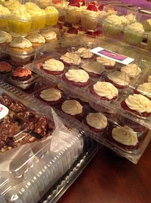 A variety of cupcakes and brownies.