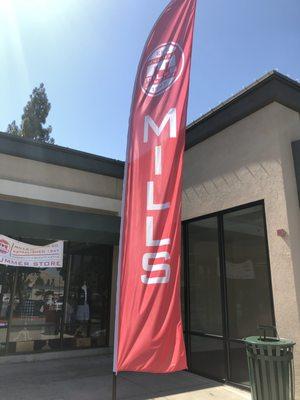 Mills red flag in front of the store.