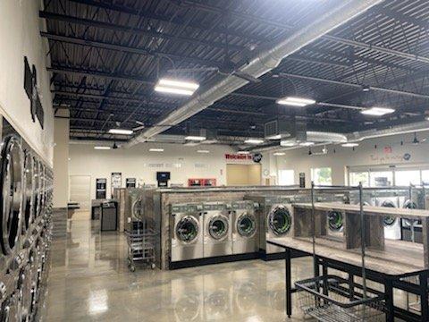 Washers, Dryers and folding areas at the Camp Hill laundromat.