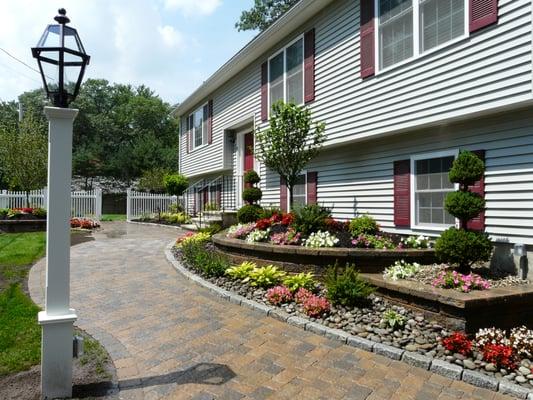 Techo-bloc Walls, walkways with cobblestone borders and low maintenance plantinds Designed and installed by Done Right Landscape