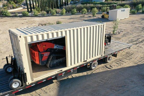 Conex Hub moving 10,000 lbs machine inside of container with remote control unit, which operates independently of trailer.