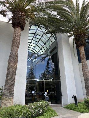 Glass doors to enter the building as a guest. Security guard on site.