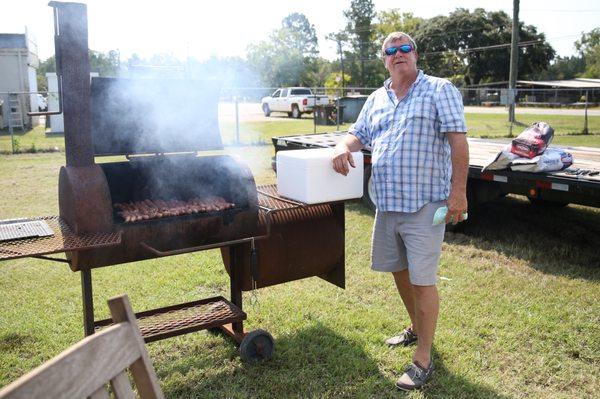 Hudson B. grilling Monroe Sausage during Customer Appreciation Saturdays!