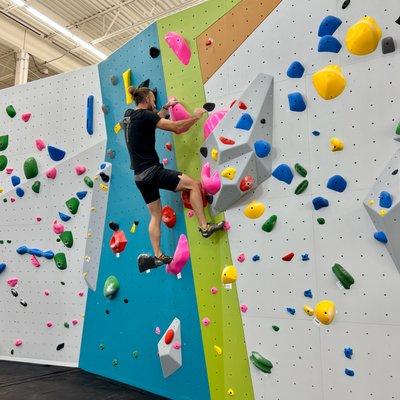 Guest climbing on bouldering wall