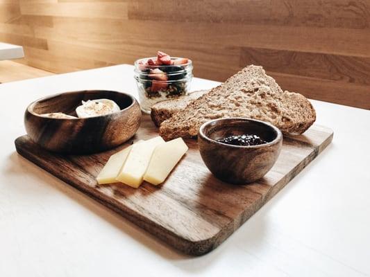 The Revelator Coffee Co. breakfast board with fresh fruit, hand-selected cheese, and toast.