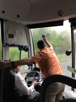 Our teacher working hard to keep the windows clear for the driver.