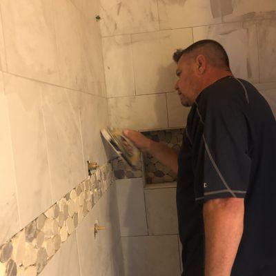 Putting some grout and the finishing touches on this tile stand up shower