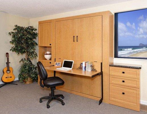 Wall bed, custom cabinets and integrated, fold-down desk in Oak Melamine.