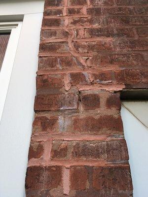 Sloppy brick pointing, see where mortar was not placed between bricks.