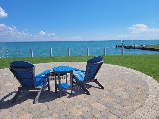 Guests enjoy the wood burning fire pit at the lakefront park with beautiful views of Lake St. Clair.