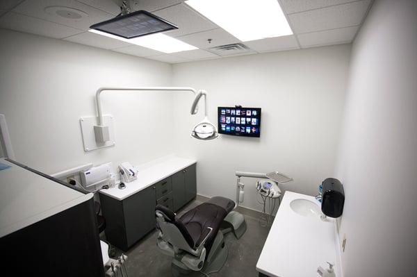 Massaging dental chairs, TVs on the ceiling and wall, and headphones for your comfort