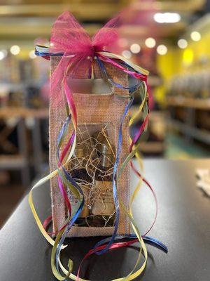 4 60 ml bottles of oil and vinegar in a burlap bag